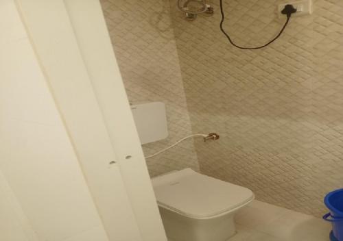 a bathroom with a white toilet in a room at Hotel Geetanjali St Bus Stand Panvel in Panvel