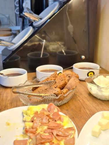 a table topped with plates of food on a table at Aura Plaza Hotel in Tbilisi City