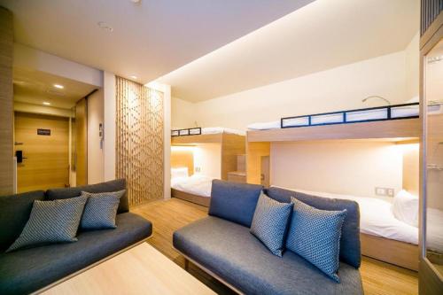a living room with two bunk beds and a couch at RESI STAY Kumico Amaterrace in Kyoto