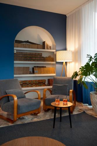 a living room with two chairs and a table at Hotel Gemma in Riccione
