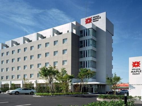 a large white building with a sign on it at Hirata Maple Hotel in Izumo