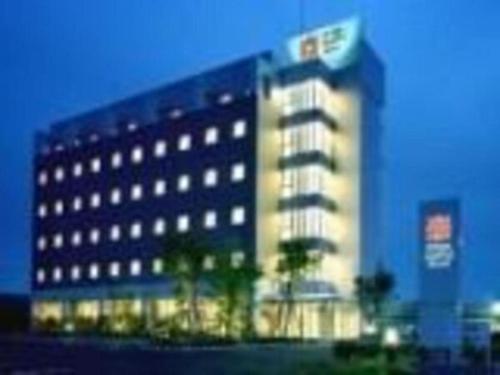 a large building with lights on in a city at Hirata Maple Hotel in Izumo