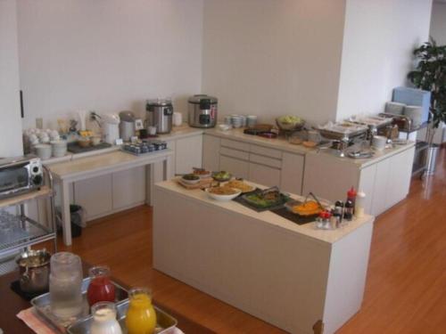 a large kitchen with a lot of food on the counters at Hirata Maple Hotel in Izumo