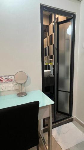 a bathroom with a table and a glass shower at In Trend Hotel in Cukai