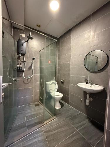 a bathroom with a shower and a toilet and a sink at Casa Boheme Empire Damansara in Petaling Jaya