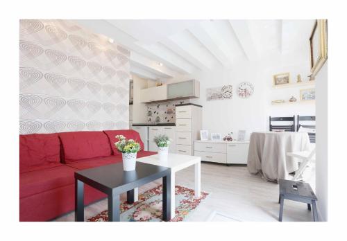 a living room with a red couch and a table at Sarajevo Apartments No.5 in Sarajevo