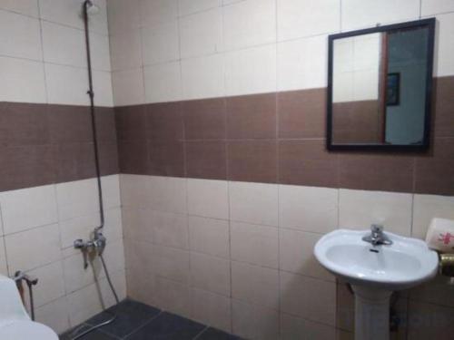 a bathroom with a sink and a mirror at OYO 90376 Centre Point Hotel in Limbang