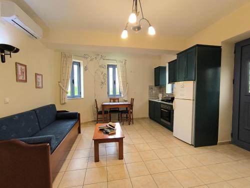 a living room with a couch and a table at Taletos Apartments in Stoupa