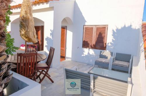 a patio with a table and chairs in a house at RUMAH Esposende in Esposende