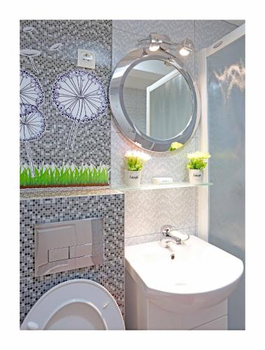 a bathroom with a sink and a mirror and a toilet at Sarajevo Apartments No.5 in Sarajevo