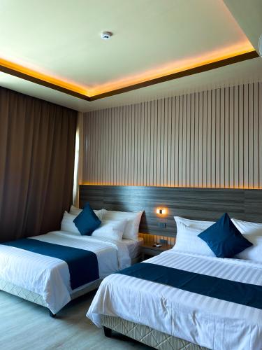 two beds in a hotel room with two at The South Hideaway Oslob 
