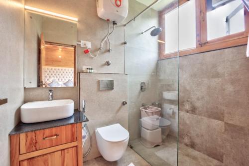 a bathroom with a toilet and a sink and a shower at Mountain Chalet By Vivaan in Shamshi
