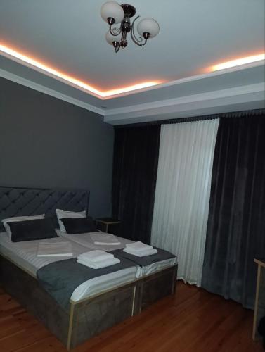 a bedroom with a large bed and a ceiling at Art Hostel in Tashkent