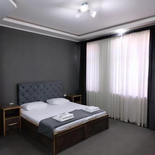 a bedroom with a large bed with a window at Art Hostel in Tashkent
