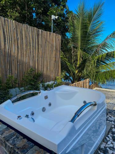 a white bath tub sitting next to a fence at The South Hideaway Oslob 