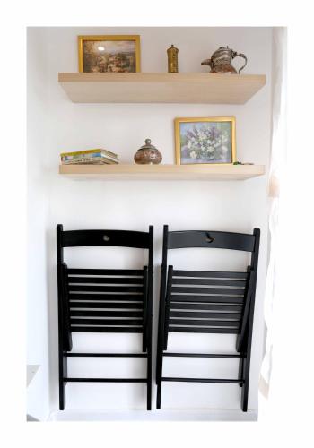 two black chairs in a room with shelves at Sarajevo Apartments No.5 in Sarajevo