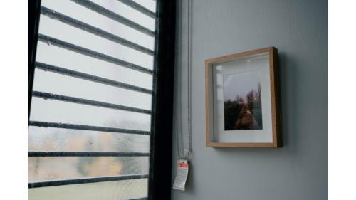 a mirror on a wall next to a window at The Ridge by Tiny Away in Korweinguboora