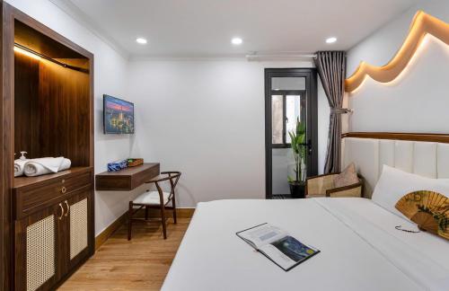 a hotel room with a bed and a desk at Jan Hostel in Ho Chi Minh City