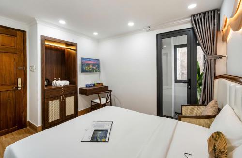 a hotel room with a bed and a window at Jan Hostel in Ho Chi Minh City
