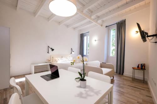 a white living room with a couch and a table at Depto in Sassari