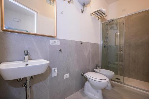 a bathroom with a toilet and a sink and a shower at Depto in Sassari