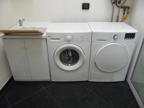 a white washer and dryer in a room at Dammuso Rossini in Ragusa