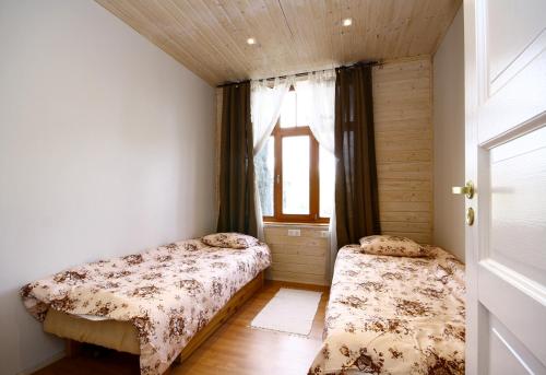 a bedroom with two beds and a window at Sadama 11 Apartment in Pärnu