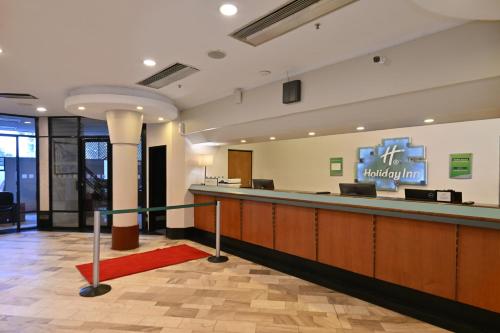a lobby of a hotel with a reception desk at Holiday Inn - Harare by IHG in Harare