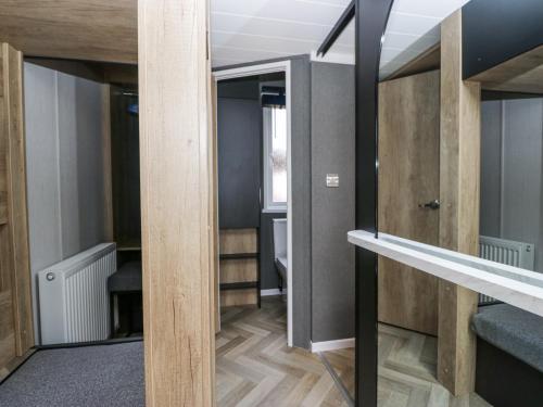 a room with wooden walls and a mirror at Lingy Luxury Family Pod in Keswick