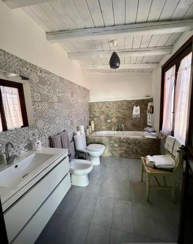 a bathroom with a tub and a toilet and a sink at Villa Taormina Sicily in Furci Siculo