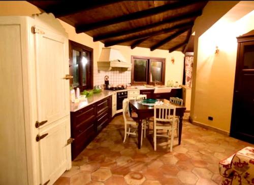 a kitchen with a table and chairs in a room at Villa Taormina Sicily in Furci Siculo