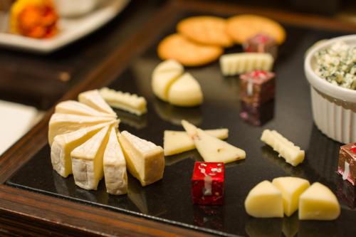 a tray of cheese and other foods on a table at Les Suites Taipei - Da An in Taipei