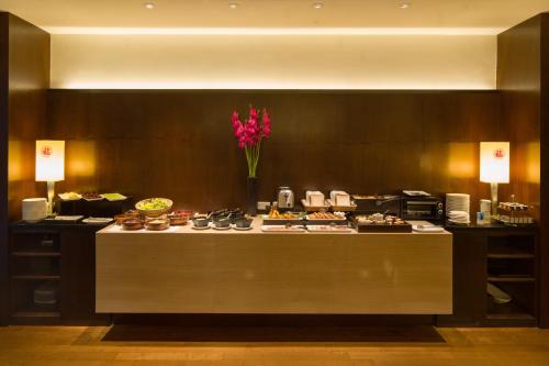 a buffet in a hotel room with cakes and pastries at Les Suites Taipei - Da An in Taipei