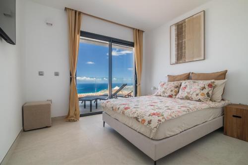 a bedroom with a bed with a view of the ocean at Presidential Suite 350m2 Bellavista on one level,Private SPA&HEATED POOL in Adeje
