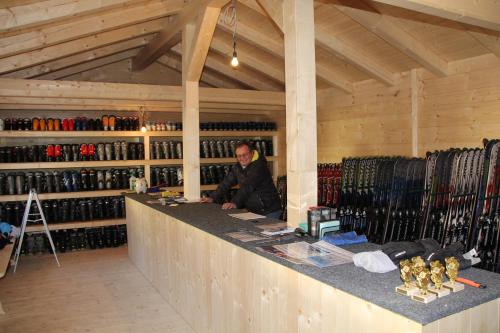 a man sitting at a counter in a store at Alpinhotel Berchtesgaden in Berchtesgaden