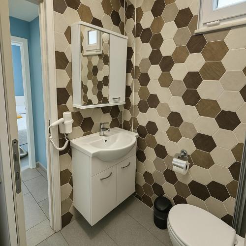a bathroom with a toilet and a sink at Nature Hotel Doğa Hotel Ölüdeniz in Fethiye
