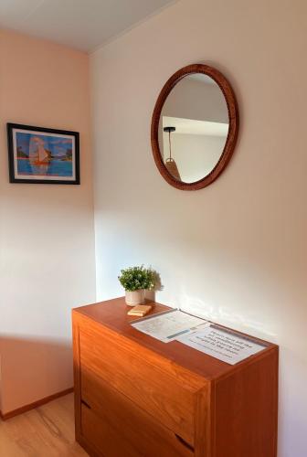 a mirror on top of a dresser in a room at Chez PASCAL et KIM in Papetoai