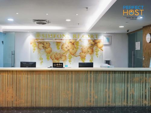 a hotel lobby with a sign that reads the bestiest situation room at Triima Inn Dayang Bay by Perfect Host in Kuah