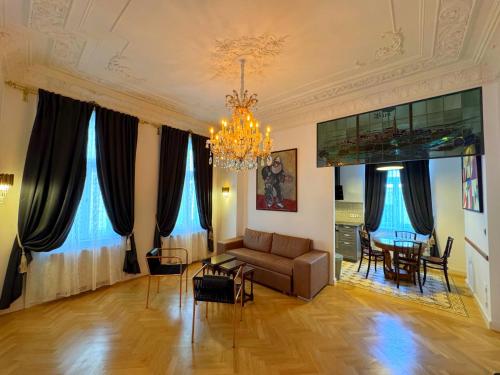 a living room with a couch and a dining room at 7th HEAVEN Vienna Center Apartments in Vienna