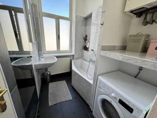 a bathroom with a washing machine and a sink at 7th HEAVEN Vienna Center Apartments in Vienna