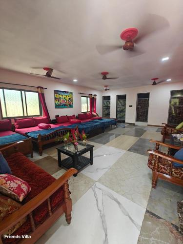 a large living room with couches and a table at Paradise Farm Alibaug in Kashid