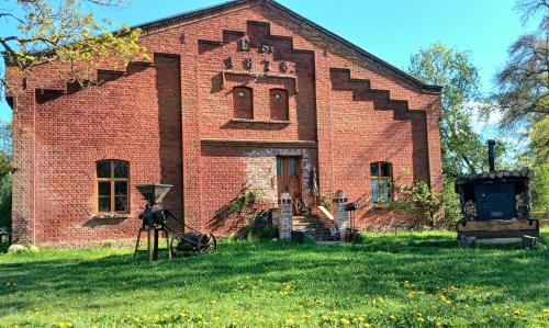 an old brick building with a camera in the yard at Ferienwohnung Sophienhof in Loitz