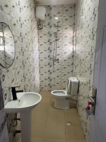 a bathroom with a toilet and a sink at The Platinum Apartment in Ibadan