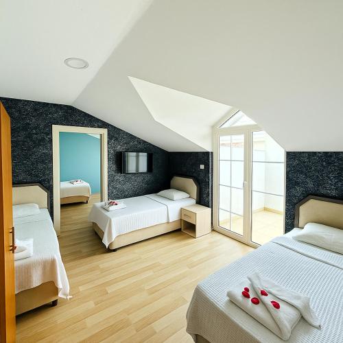 a attic bedroom with two beds and a mirror at Nature Hotel Doğa Hotel Ölüdeniz in Fethiye