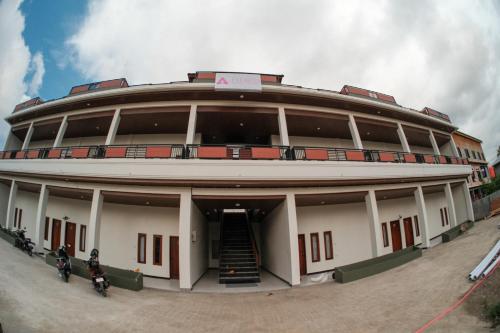 a large building with two motorcycles parked in front of it at Ntala in Komodo Labuan Bajo Airport
