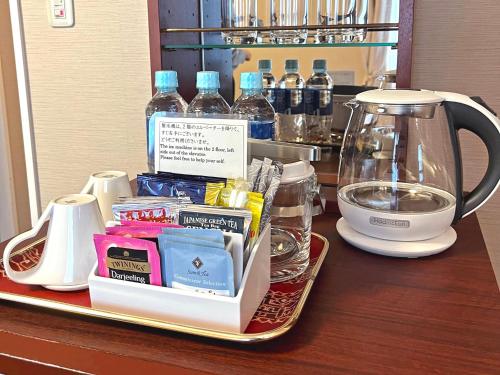 a tray with a tea kettle and other items on a counter at Shibuya Creston Hotel in Tokyo