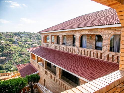 a brick building with a red roof at Heri guest house in Johannesburg