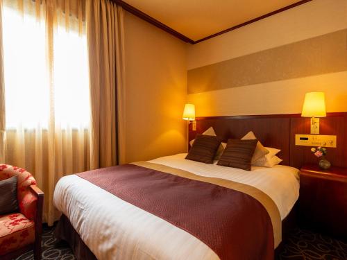 a hotel room with a large bed and a window at Shibuya Creston Hotel in Tokyo