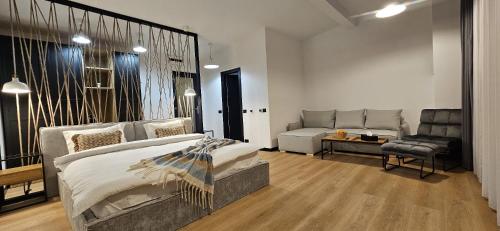 a bedroom with a bed and a couch in it at SteLar Lake View 2025 in Teşila
