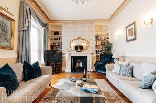 a living room with a couch and a fireplace at Central Townhouse with Garden & Free Parking in Bath